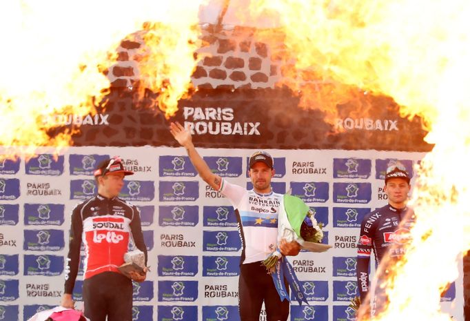 Cycling - Paris-Roubaix - Roubaix, France October 3, 2021  Italy's Sonny Colbrelli celebrates on the podium after winning the race alongside second place Belgium's Floria