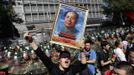 A demonstrator holding a poster of China's late Chairman Mao Zedong yells slogans during a protest against Japan's purchase of the disputed Senkaku or Diaoyu islands outside the Japanese embassy in Beijing September 15, 2012. Thousands of protesters besieged the Japanese embassy in Beijing on Saturday, hurling rocks and bottles at the building as police struggled to keep control, amid growing tensions between Asia's two biggest economies over a group of disputed islands. REUTERS/Jason Lee (CHINA - Tags: POLITICS CIVIL UNREST TPX IMAGES OF THE DAY)