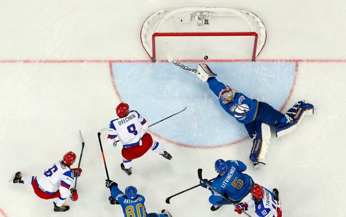 Russia's Sergei Plotinikov (L) scores past Kazakhstan's goalie Alexei Ivanov (R) after a pass by team mate Alexander Ovechkin (8) during the first period of their men's i