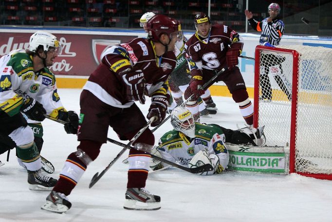 Hokejisté klubu HC Sparta Praha Petr Ton (vlevo) a Michal Broš se snaží vstřelit gól za záda Tomáše Závorky v prvním kole hokejové extraligy 2012/13 s Karlovými Vary.