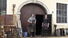 Blacksmith brothers Johann (R) and Georg Schmidberger stand in front of their workshop in Molln, Upper Austria June 12, 2012. Johann, 29, and Georg, 28, produce made-to-order handmade harnesses for the Vatican, which take 120 hours of handiwork per piece and hardly differs from the 500-year-old originals. The brothers carry on the tradition of the blacksmith trade in the fifth generation of their family. REUTERS/Lisi Niesner (AUSTRIA - Tags: SOCIETY MILITARY) Published: Čer. 12, 2012, 10:15 odp.