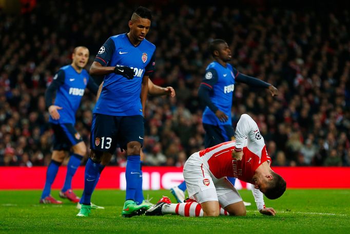 Football: Arsenal's Olivier Giroud looks dejected after missing a chance to score as Monaco's Fortuna Wallace Santos looks on