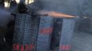 A coal miner hides behind shields, which read "miners", as he fires a home-made rocket during a clash with Spanish national riot police inside the "El Soton" coal mine in El Entrego, near Oviedo, northern Spain June 15, 2012. The miners were protesting against the government's proposal to decrease funding for coal production. REUTERS/Eloy Alonso (SPAIN - Tags: CIVIL UNREST BUSINESS EMPLOYMENT ENERGY TPX IMAGES OF THE DAY) Published: Čer. 15, 2012, 11:50 dop