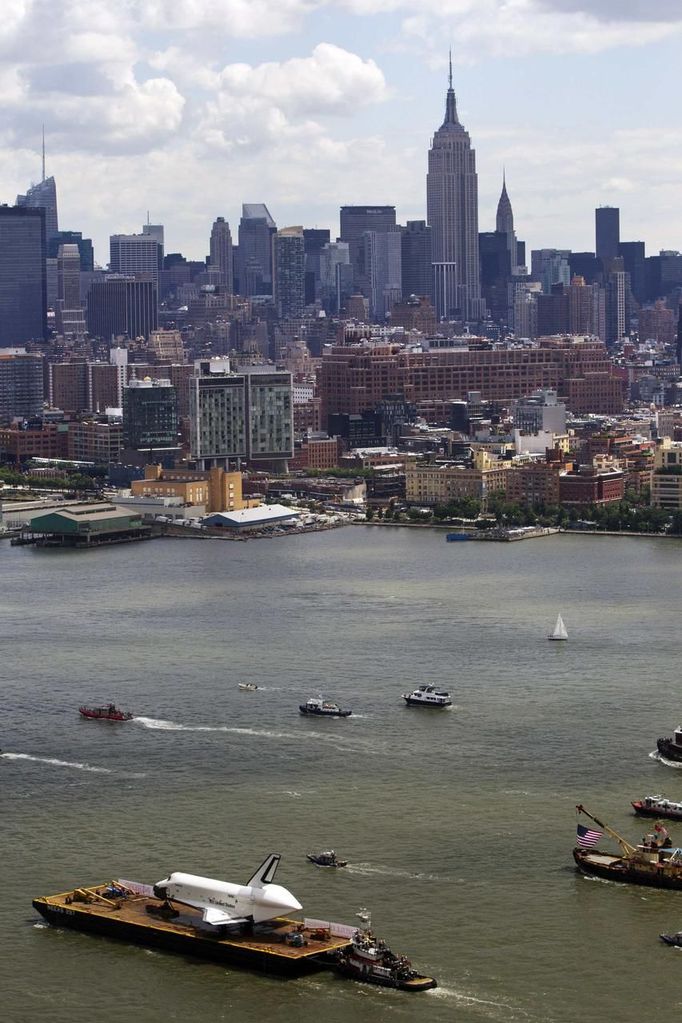 The Space Shuttle Enterprise floats up the Hudson River June 6, 2012, past the New York skyline as it rides on a barge to be placed at the Intrepid Sea, Air and Space Museum. REUTERS/Lucas Jackson (UNITED STATES - Tags: SCIENCE TECHNOLOGY TRANSPORT) Published: Čer. 6, 2012, 4:38 odp.