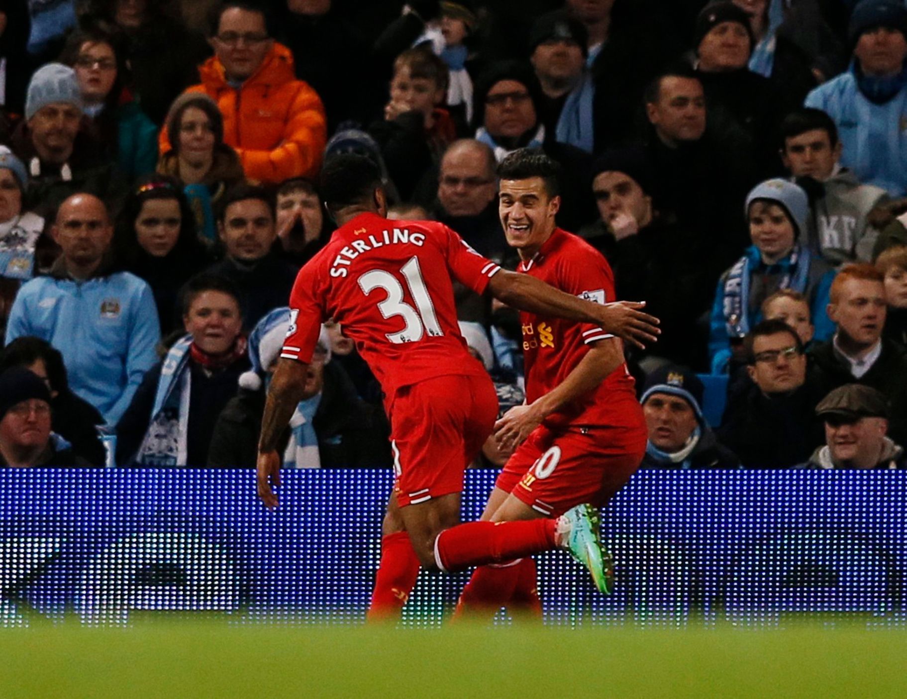 Liverpool's Coutinho celebrates with teammate Sterling after scoring a goal against Manchester City during their English Premier League soccer match in Manchester