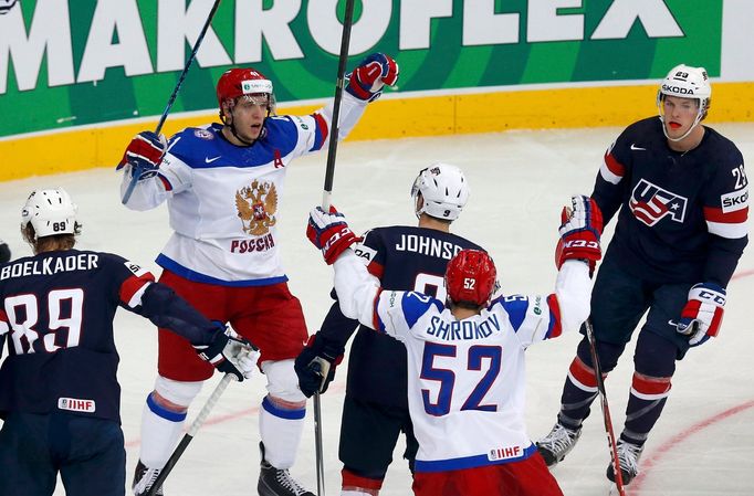 Russia's Nikolai Kulyomin (top, L) celebrates his goal against the U.S. during the first period of their men's ice hockey World Championship group B game at Minsk Arena i