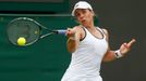 Marina Erakovic of New Zealand hits a return to Peng Shuai of China during their women's singles tennis match at the Wimbledon Tennis Championships, in London June 27, 20