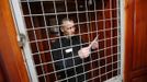 Inmate Boris Kovalyov, 32, stands inside a cell as he receives a letter from his wife at a high-security male prison camp outside Russia's Siberian city of Krasnoyarsk April 30, 2013. Kovalyov was sentenced to eight years in a high-security prison camp for drug trafficking, but was released two and a half years early, on May 10, 2013, for good behaviour and participation in sports and cultural activities. Before being released, Kovalyov had been serving part of his sentence in high-security male prison camp number 5, intended to house male inmates who have multiple convictions for serious crimes. Prisoners at the facility work in wood and metal processing shops, manufacture furniture, sew clothes and do other kinds of work. They can also take part in educational, sport and cultural programs. Picture taken April 30, 2013. REUTERS/Ilya Naymushin (RUSSIA - Tags: CRIME LAW SOCIETY TPX IMAGES OF THE DAY) ATTENTION EDITORS: PICTURE 27 OF 29 FOR PACKAGE 'INSIDE SIBERIA'S PRISONS' SEARCH 'ILYA PRISON' FOR ALL IMAGES Published: Čer. 19, 2013, 10:05 dop.