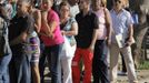 Luis Salgado, nicknamed Chucho, (in red pants) waits in line with other Cubans to pick up his visa at the U.S. Interests Section in Havana, February 25, 2013. Chucho's visa application, based on his father's status as legal resident in the U.S., was approved and he was reunited in Miami with his father, Jesus Salgado, who had escaped Cuba on a frail boat ten years earlier. The Salgados are among many Cubans taking advantage of Cuba's new travel policy in place since last January, which allows citizens to leave the country with just a passport and no need for much-hated exit visas required since 1961. Picture taken February 25, 2013. REUTERS/Desmond Boylan (CUBA - Tags: POLITICS SOCIETY) Published: Dub. 11, 2013, 2:10 odp.