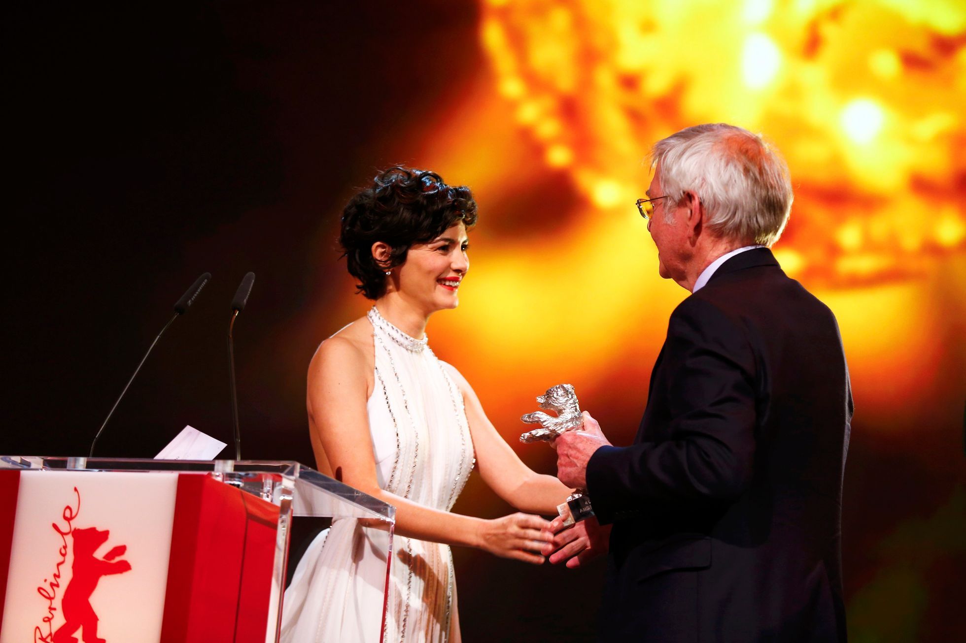 Actress Tautou hands over the Silver Bear for Best Actor for the film '45 Years' to actor Courtenay at the awards ceremony of the 65th Berlinale International Film Festival in Berlin