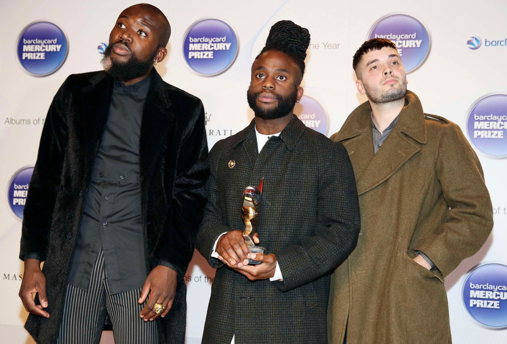 Young Fathers pose with their trophy after winning the 2014 Mercury Prize in London