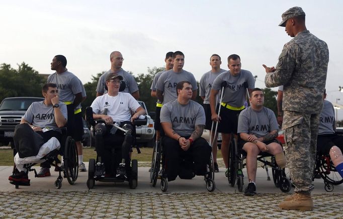 Sgt. Matt Krumwiede of the U.S. Army (front, 2nd L) lines up for morning formation at Brooke Army Medical Center in San Antonio, Texas August 1, 2013. On June 12, 2012, Krumwiede was on patrol in Afghanistan when he stepped on an IED, which tore away both his legs, damaged his left arm, and ripped open his abdominal cavity. The 22-year-old has since undergone around 40 surgeries and is learning to walk with prosthetic legs. He is keen to re-join the infantry as soon as his injuries allow. U.S. troops have been in Afghanistan since 2001. Thousands of Afghan elders gathered in Kabul on November 21, 2013 at a Loya Jirga, or grand council, to debate a crucial security pact with the United States, a day after Kabul and Washington reached a draft agreement laying out the terms under which U.S. troops may stay beyond 2014. Picture taken August 1, 2013.