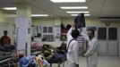 Doctors look at an x-ray at the emergency ward of a local hospital in San Pedro Sula March 28, 2013. San Pedro Sula, the country's second largest city after Tegucigalpa, has a homicide rate of 169 per 100,000 people and was named the world's most violent city for a second year in a row. Lax laws allow civilians to own up to five personal guns. Arms trafficking has flooded the country with nearly 70% illegal firearms. 83.4% of homicides are by firearms, compared to 60% in the United States. Picture taken March 28, 2013. REUTERS/Jorge Cabrera (HONDURAS - Tags: CRIME LAW CIVIL UNREST HEALTH) ATTENTION EDITORS: PICTURE 21 OF 39 FOR PACKAGE 'GUN CULTURE - HONDURAS' SEARCH 'HONDURAS GUN' FOR ALL IMAGES Published: Dub. 5, 2013, 11:15 dop.