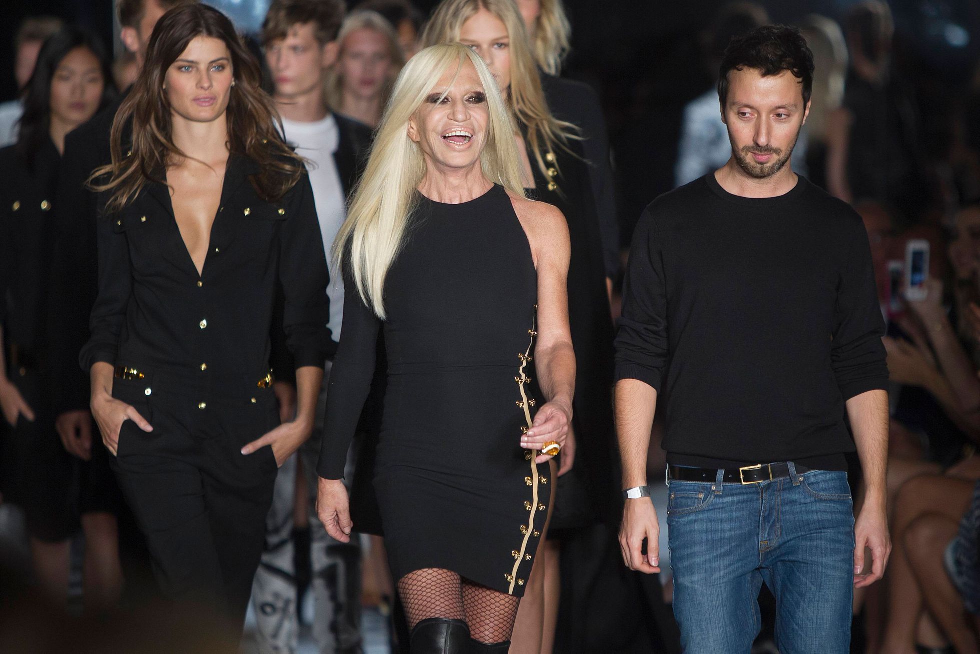Designer Donatella Versace smiles on the runway after the Versus Versace Spring/Summer 2015 collection show during New York Fashion Week