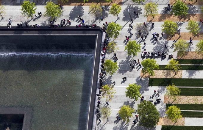 Attendees of the 9/11 Memorial are seen from the 90th story of One World Trade Center in New York, April 30, 2012. The addition of iron columns to the 100th story pushed the height of One World Trade above that of the Empire State Building today. REUTERS/Lucas Jackson (UNITED STATES - Tags: CITYSPACE SOCIETY TPX IMAGES OF THE DAY) Published: Kvě. 1, 2012, 5:34 dop.