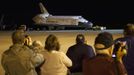 People take photos as the space shuttle Discovery is being towed for the last time out of the Vehicle Assembly Building to the Mate Demate Facility at Kennedy Space Center