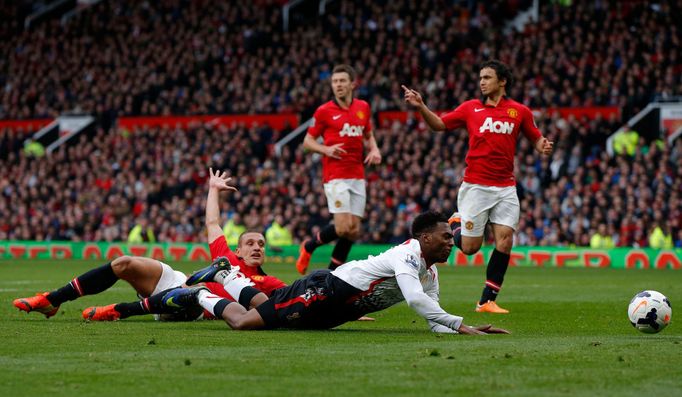 Manchester United's Vidic fouls Liverpool's Sturridge to concede a penalty and be sent off during their English Premier League soccer match at Old Trafford in Manchester