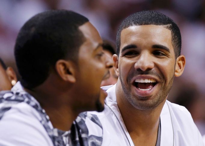 Musical recording artist Drake wathces the Miami Heat play the San Antonio Spurs in Game 7 of their NBA Finals basketball playoff in Miami, Florida June 20, 2013. REUTERS