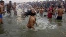 Hindu devotees take dip during the first "Shahi Snan" (grand bath) at the ongoing "Kumbh Mela", or Pitcher Festival, in the northern Indian city of Allahabad January 14, 2013. Upwards of a million elated Hindu holy men and pilgrims took a bracing plunge in India's sacred Ganges river to wash away lifetimes of sins on Monday, in a raucous start to an ever-growing religious gathering that is already the world's largest. REUTERS/Jitendra Prakash (INDIA - Tags: RELIGION SOCIETY) Published: Led. 14, 2013, 12:11 odp.