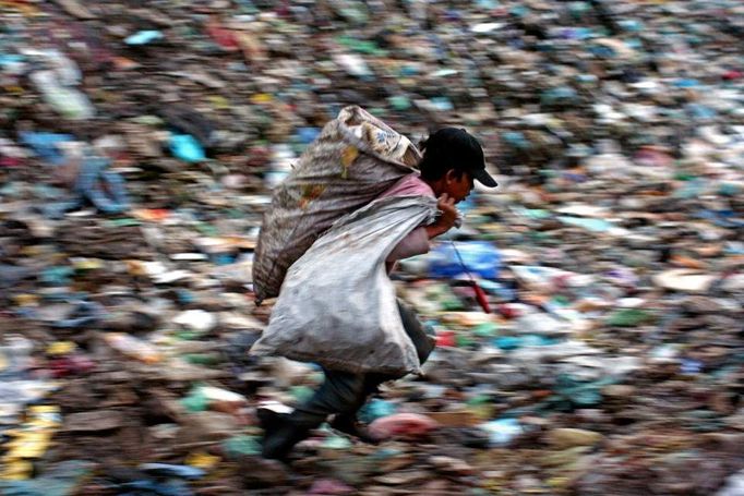 Těžká práce dětí na skládce v Phnompenhu, Kambodža, říjen 2007. "Skládka Stung Meanchey leží na periférii kambodžského hlavního města Phnompenhu. Stovky dětí holýma rukama či pomocí zahnutého drátu prohledávají v navezených odpadcích ve dne i v noci za jakéhokoliv počasí plasty, kovy, papír a plechovky od nápojů, vše, co se dá recyklovat."