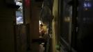 Akee, 34, who works as a waiter rests in a wooden box that he lives in Hong Kong October 9, 2012. In Hong Kong's middle-class residential area, short distance from its shopping and financial districts, 24 people live in these wooden boxes, or "coffin homes", packed in a single apartment of little over 50 square meters. Its residents pay 1450 Hong Kong dollars ($180) for their living space built of wooden panels of 2 meters by 70 cm. To maximize income from the rent in central Hong Kong landlords build "coffin homes", nicknamed due to their resemblance to real coffins. Space has always been at a premium in Hong Kong where developers plant high-rises on every available inch. REUTERS/Damir Sagolj (CHINA - Tags: SOCIETY REAL ESTATE BUSINESS) Published: Říj. 9, 2012, 1:42 odp.