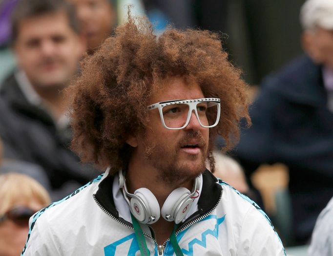 Stefan Kendal Gordy, known as Redfoo, of the band LMFAO, watches his girlfriend Victoria Azarenka of Belarus after she defeated Maria Joao Koehler of Portugal in their wo