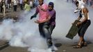 Protesters try to kick a tear gas canister that was thrown by the riot police away, during clashes along a road which leads to the U.S. embassy, near Tahrir Square in Cairo September 13, 2012. Egypt's President Mohamed Mursi said on Thursday he supported peaceful protests but not attacks on embassies, after Egyptians angry at a film deemed insulting to the Prophet Mohammad climbed into the U.S. embassy in Cairo and tore down the U.S. flag. He pledged to protect foreigners in Egypt.