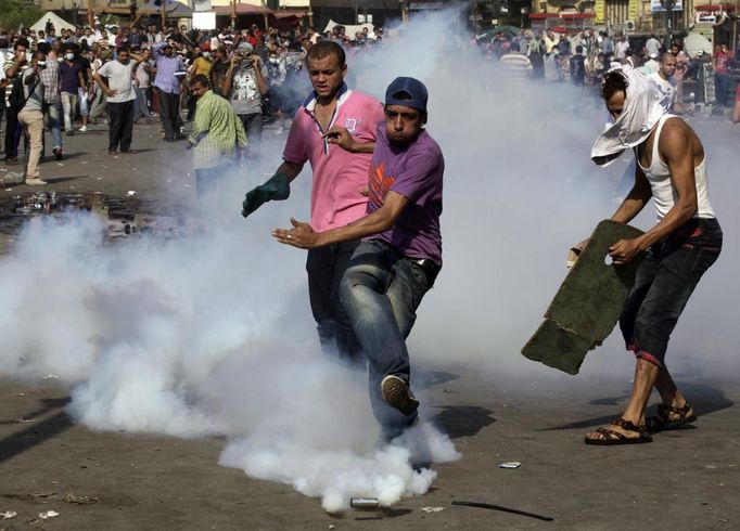 Protesters try to kick a tear gas canister that was thrown by the riot police away, during clashes along a road which leads to the U.S. embassy, near Tahrir Square in Cairo September 13, 2012. Egypt's President Mohamed Mursi said on Thursday he supported peaceful protests but not attacks on embassies, after Egyptians angry at a film deemed insulting to the Prophet Mohammad climbed into the U.S. embassy in Cairo and tore down the U.S. flag. He pledged to protect foreigners in Egypt.