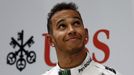 First-placed Mercedes Formula One driver Lewis Hamilton of Britain looks up as he stands on the winners' podium during the Chinese F1 Grand Prix at the Shanghai Internati