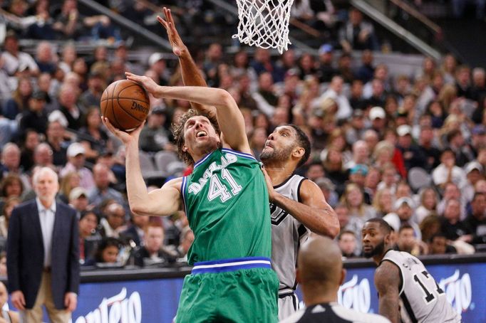 Dallas Mavericks power forward Dirk Nowitzki (41) shoots the ball as San Antonio Spurs power forward Tim Duncan (behind) defends