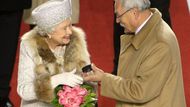 The Queen is being handed a puck and some strategic advise from President Gašparovič.