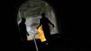 Coal miners walk inside a train tunnel which they have blocked, along the Madrid-Gijon railway during a protest against government spending cuts in the mining sector in Cinera, northern Spanish province of Leon June 11, 2012. REUTERS/Eloy Alonso (SPAIN - Tags: CIVIL UNREST BUSINESS EMPLOYMENT ENERGY TPX IMAGES OF THE DAY) Published: Čer. 11, 2012, 3:44 odp.