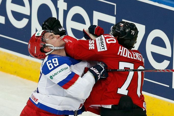 Russia's Alexander Burmistrov (L) clashes with Switzerland's Denis Hollenstein (R) during their men's ice hockey World Championship Group B game at Minsk Arena in Minsk M