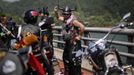 A Harley Davidson rider dances as he takes a break during the annual Harley Davidson National Rally in Qian Dao Lake, in Zhejiang Province May 11, 2013. Around 1,000 Harley Davidson enthusiasts from all over China met to celebrate the 5th Harley Davidson National Rally in China, as part of the company's 110-year anniversary. Major Chinese cities ban motorcycles from circulating on highways and major avenues. Meanwhile, Harley Davidson motorbikes are considered by Chinese tax authorities to be luxury items, so they are taxed at extremely high rates-- sometimes the taxes alone is equivalent to the bike's U.S. price tag. Traffic and transportation authorities have also weighed in, putting Harleys in the same category as electric bikes, horses and bicycles, meaning that they cannot be on highways and major avenues. Picture taken May 11, 2013. REUTERS/Carlos Barria (CHINA - Tags: TRANSPORT SOCIETY) Published: Kvě. 13, 2013, 11:04 odp.