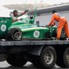 The car of Caterham Formula One driver Ericsson of Sweden is removed from the tracks after Ericsson crashed during the qualifying session for the Malaysian F1 Grand Prix at Sepang International Circui