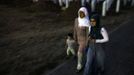 Bosnian Muslims walk during twilight through Memorial Center in Potocari where there will be a mass burial, near Srebrenica July 9, 2012. The bodies of 520 recently identified victims of the Srebrenica massacre will be buried on July 11, the anniversary of the massacre when Bosnian Serb forces commanded by Ratko Mladic slaughtered 8,000 Muslim men and boys and buried them in mass graves, in Europe's worst massacre since World War Two. REUTERS/Dado Ruvic (BOSNIA - Tags: POLITICS CONFLICT ANNIVERSARY) Published: Čec. 9, 2012, 7:46 odp.