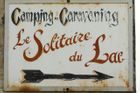 Cedule turistického kempu Le Solitaire du Lac v Savojských Alpách, kde byly nalezeny oběti záhadné vraždy.