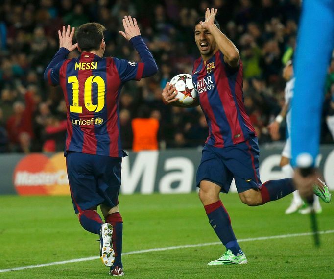 Barcelona's Lionel Messi celebrates with team-mate Luis Suarez after scoring a goal against Paris St Germain during their Champions League Group F soccer match at the Nou