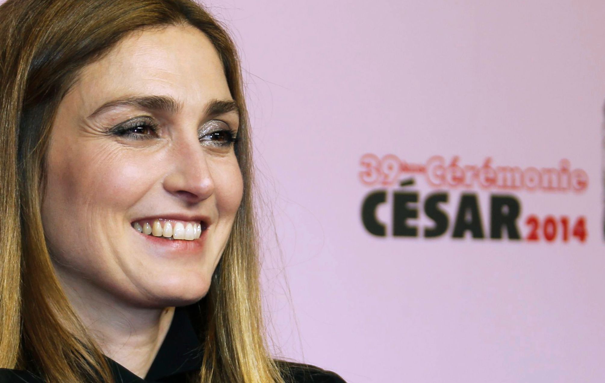 French actress Julie Gayet poses as she arrives at the 39th Cesar Awards ceremony in Paris