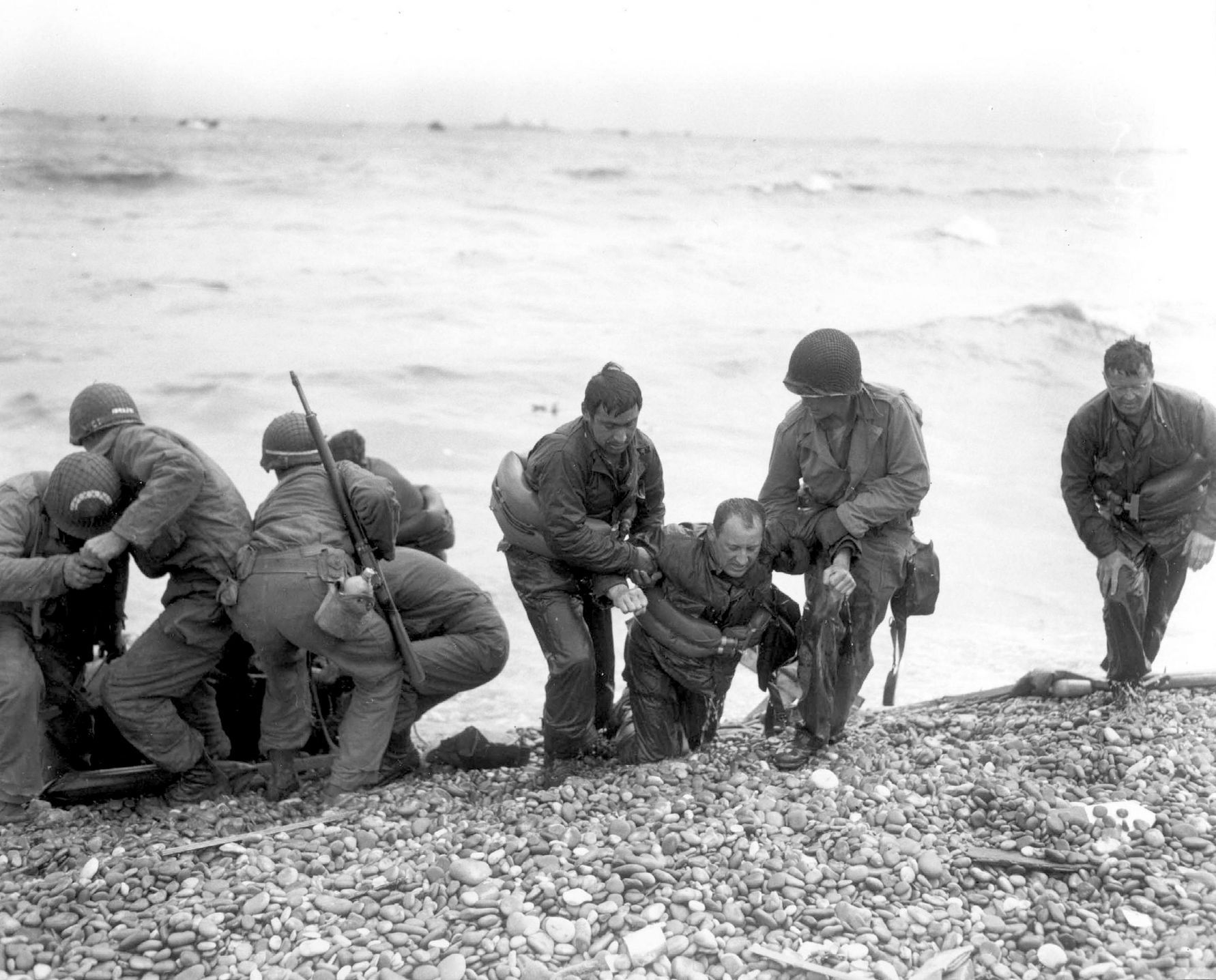 Handout photo of members of an American landing party assisting troops  near Colleville sur Mer