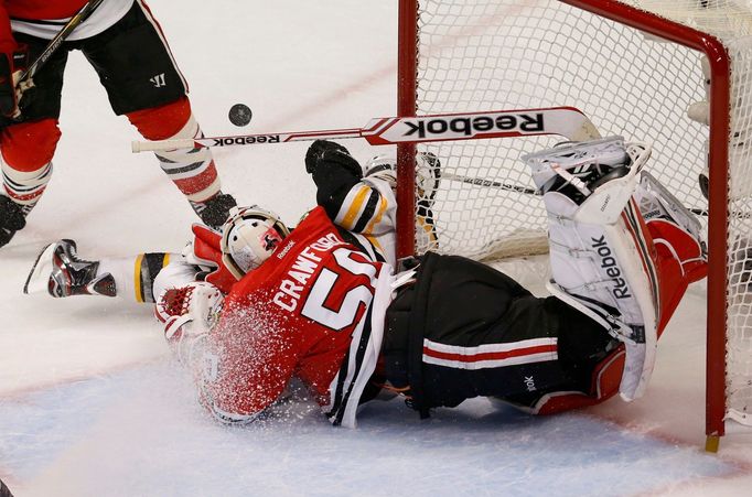 Boston Bruins' Daniel Paille collides with Chicago Blackhawks goalie Corey Crawford during the third period in Game 1 of their NHL Stanley Cup Finals hockey series in Chi