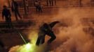 A protester, who opposes Egyptian President Mohamed Mursi, throws a tear gas canister, which was thrown earlier by the riot police, during clashes in front of the presidential palace in Cairo February 11, 2013. Protesters demanding the departure of Egyptian President Mohamed Mursi clashed with police outside his palace on Monday on the second anniversary of the overthrow of veteran autocrat Hosni Mubarak. REUTERS/Amr Abdallah Dalsh (EGYPT - Tags: POLITICS CIVIL UNREST) Published: Úno. 11, 2013, 11:57 odp.