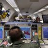 A controller sits at screens aboard a NATO AWACS aircraft during a surveillance flight over Romania
