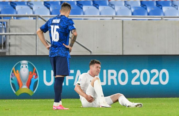 James McCarthy reacts after sustaining an injury alongside Slovakia’s Robert Mazáň