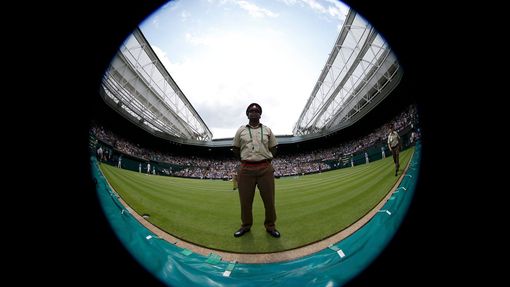 A soldier stands on Centre Court at the Wimbledon Tennis Championships, in London June 25, 2013. Photograph taken with a fish-eye lens. REUTERS/Eddie Keogh (BRITAIN - Tag