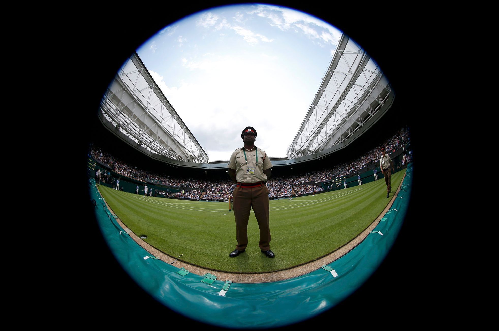 A soldier stands on Centre Court at the Wimbledon Tennis Cha