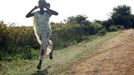 A woman runs along a road during an air strike by the Sudanese air force in Rubkona near Bentiu