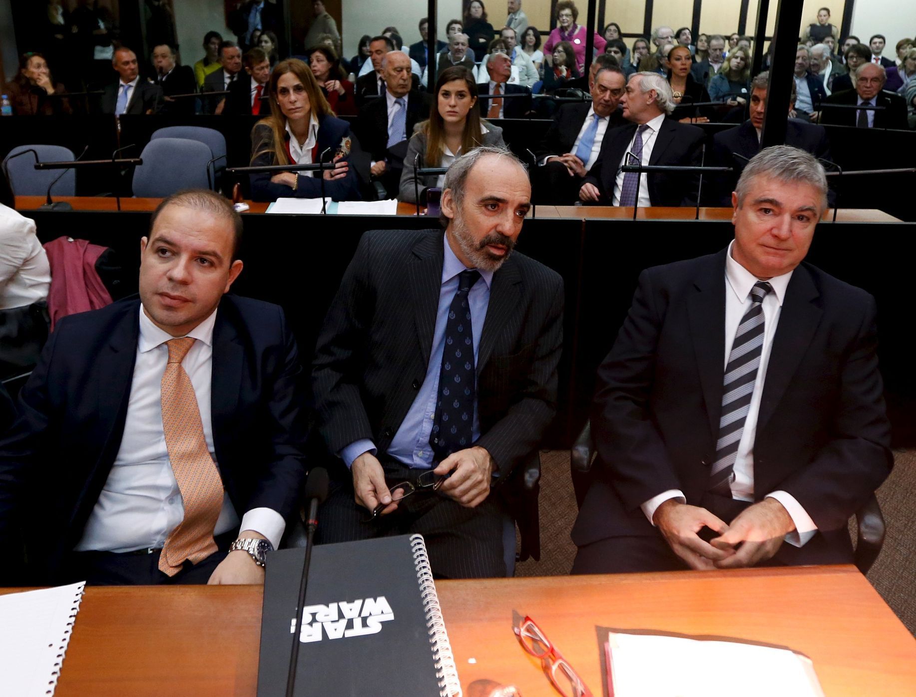 Former Argentine federal judge Galeano sits in court flanked by two unidentified attornies in Buenos Aires