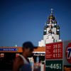 People walk past a gas station as a Russian Orthodox Church is seen in the distance in Hollywood, California