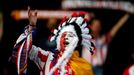 An Atletico Madrid supporter cheers before their Champions League final soccer match against Real Madrid at a fan zone at Vicente Calderon stadium in Madrid May 24, 2014.